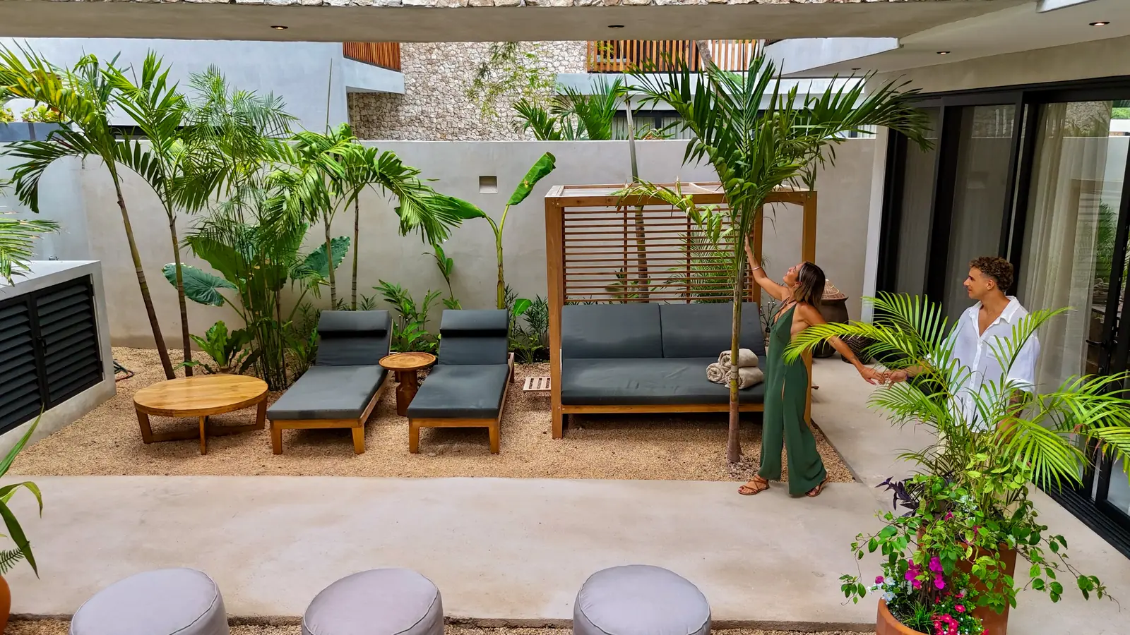 Terrace with loungers among tropical planting at a villa in Tulum