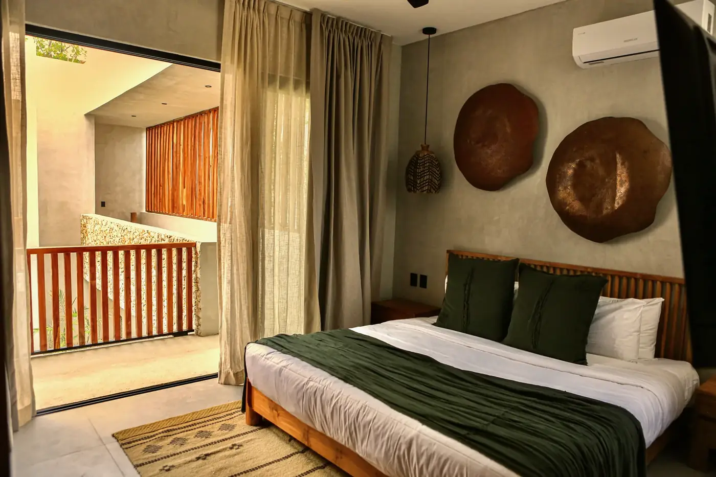 A king suite with a garden-facing wall of glass