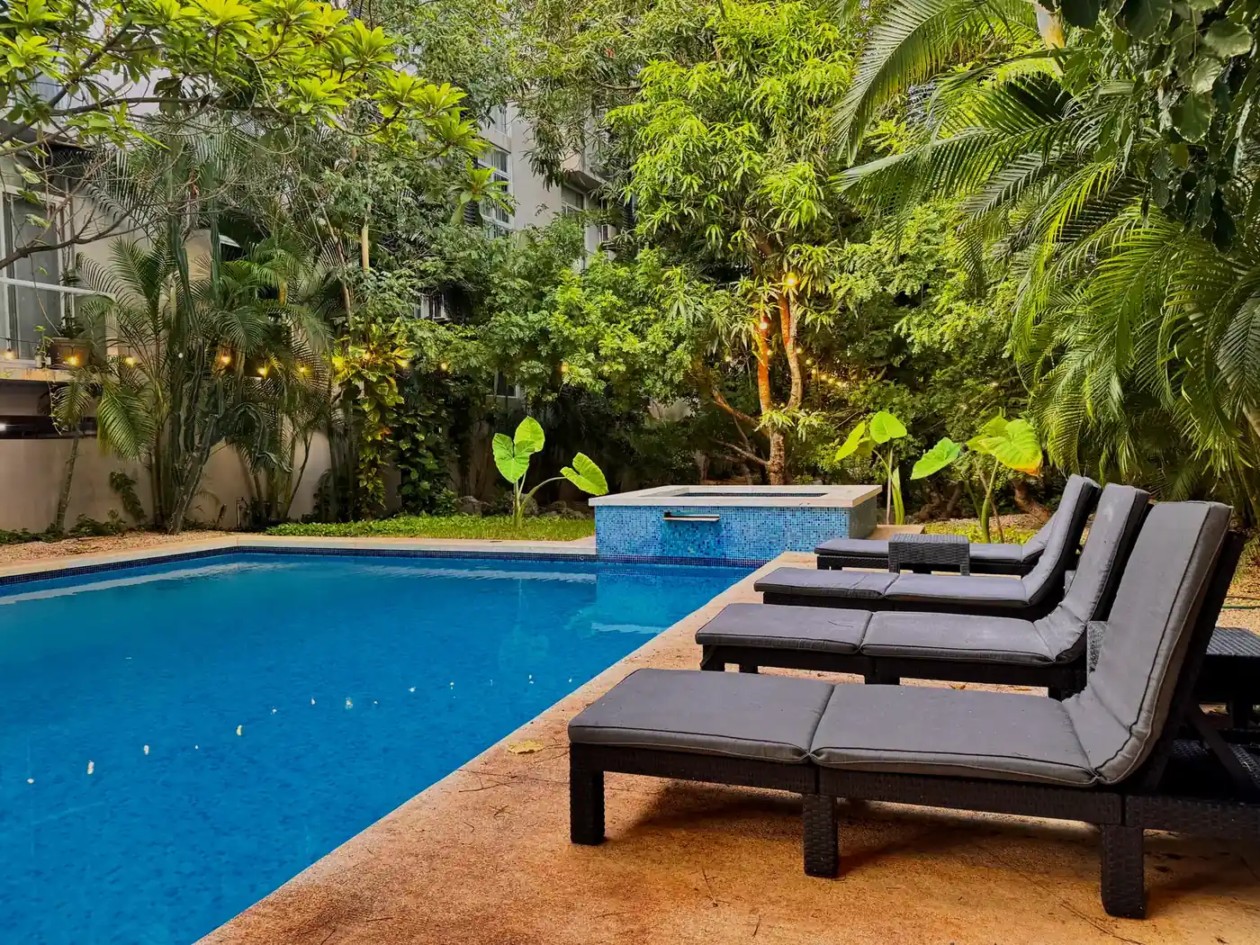 The building pool with loungers at Riviera Towers