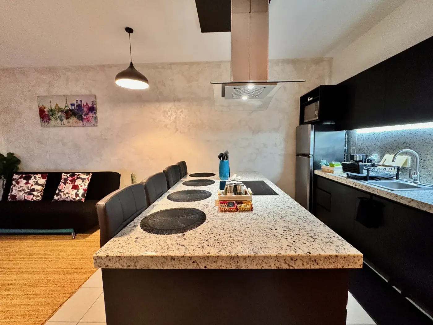 The kitchen island opening onto the living area