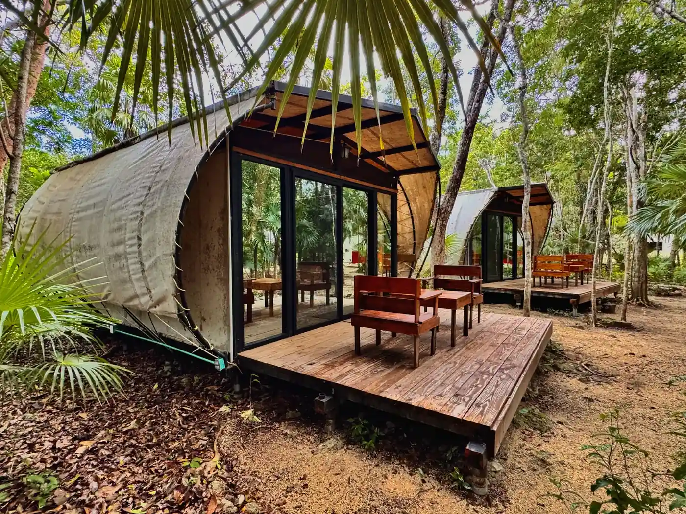 A cabin and its wooden deck among the jungle trees